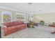 Living room with tiled floors, large windows, and a red couch at 6170 7Th N Ave, St Petersburg, FL 33710