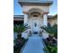 Welcoming entryway with columns, potted plants, and decorative lion statues at 6190 107Th N Ave, Pinellas Park, FL 33782