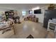 Kitchen area with shelving, a refrigerator, and a TV at 6190 107Th N Ave, Pinellas Park, FL 33782