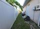 Side yard with fence and some yard debris at 6190 107Th N Ave, Pinellas Park, FL 33782