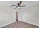 Bedroom with double doors to closet and wood-look floors at 6629 Travis Blvd, Tampa, FL 33610