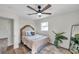 Bright bedroom with ceiling fan and wood-look floors at 6629 Travis Blvd, Tampa, FL 33610