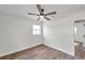 Spacious bedroom featuring wood-look floors and a ceiling fan at 6629 Travis Blvd, Tampa, FL 33610