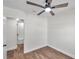 Bedroom with ceiling fan and adjacent bathroom at 6629 Travis Blvd, Tampa, FL 33610