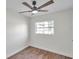 Bright bedroom with ceiling fan and wood-look floors at 6629 Travis Blvd, Tampa, FL 33610