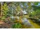 Peaceful canal view with lush vegetation, ideal for relaxing at 6629 Travis Blvd, Tampa, FL 33610