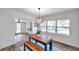 Dining room with wood table, bench, and view of backyard at 6629 Travis Blvd, Tampa, FL 33610