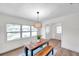 Charming dining room with wood table, bench seating, and a stylish light fixture at 6629 Travis Blvd, Tampa, FL 33610