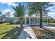 Newly renovated home with covered porch and landscaped yard at 6629 Travis Blvd, Tampa, FL 33610