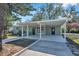 Newly renovated home with covered porch and landscaped yard at 6629 Travis Blvd, Tampa, FL 33610