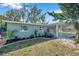 Green house with carport and nicely manicured lawn at 6629 Travis Blvd, Tampa, FL 33610