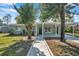 Newly renovated home with covered porch and landscaped yard at 6629 Travis Blvd, Tampa, FL 33610