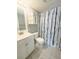 Updated bathroom with white vanity, patterned tile floor, and shower/tub combo at 8609 Mallard Reserve Dr # 103, Tampa, FL 33614