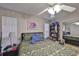 Spacious bedroom with floral bedding, ceiling fan, and ample closet space at 8609 Mallard Reserve Dr # 103, Tampa, FL 33614