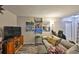 Living room with gray couch, TV stand and wall art at 8609 Mallard Reserve Dr # 103, Tampa, FL 33614