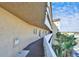 Long view of exterior balcony, showcasing palms and open sky at 8950 Park Blvd # 406, Seminole, FL 33777