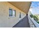 View down a condo complex balcony, featuring a textured surface at 8950 Park Blvd # 406, Seminole, FL 33777