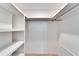 Walk-in closet with empty shelves and hanging rack at 8950 Park Blvd # 406, Seminole, FL 33777