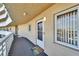 Condominium exterior entrance showcasing welcome mat, neutral stucco, and access to the common area walkway at 8950 Park Blvd # 406, Seminole, FL 33777