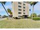 Exterior view of condominium with landscaped lawn, tall windows, and screened entryways at 8950 Park Blvd # 406, Seminole, FL 33777