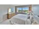 Comfortable main bedroom featuring a plush bed, golf course view, and a wooden dresser at 8950 Park Blvd # 406, Seminole, FL 33777