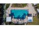 Aerial shot of the community pool surrounded by lounge chairs, tables, and shade canopies at 8950 Park Blvd # 406, Seminole, FL 33777