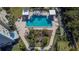 Bird's eye view of the community pool showcasing lounge chairs, shaded cabanas, and nearby lush landscaping at 8950 Park Blvd # 406, Seminole, FL 33777