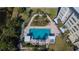 Aerial view of the community pool, with lounge chairs and well-manicured landscaping surrounding it at 8950 Park Blvd # 406, Seminole, FL 33777