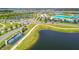 Community aerial showcasing lagoon, roads and homes at 9114 Forge Breeze Loop, Wesley Chapel, FL 33545