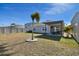 Backyard view showing patio, grass, and trees at 9114 Forge Breeze Loop, Wesley Chapel, FL 33545