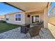 Relaxing backyard patio with covered seating area and fire pit at 9114 Forge Breeze Loop, Wesley Chapel, FL 33545