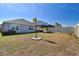 Home's backyard with covered patio and grassy area at 9114 Forge Breeze Loop, Wesley Chapel, FL 33545