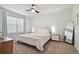 Bright bedroom with a queen-size bed and large window at 9114 Forge Breeze Loop, Wesley Chapel, FL 33545