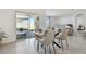 Bright dining area with glass table and modern chairs at 9114 Forge Breeze Loop, Wesley Chapel, FL 33545