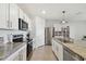 Modern kitchen with stainless steel appliances and granite countertops at 9114 Forge Breeze Loop, Wesley Chapel, FL 33545