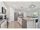 Modern kitchen with stainless steel appliances and granite countertops at 9114 Forge Breeze Loop, Wesley Chapel, FL 33545