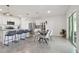 Bright kitchen features modern appliances and an island with seating at 9114 Forge Breeze Loop, Wesley Chapel, FL 33545