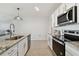 Modern kitchen with stainless steel appliances and granite countertops at 9114 Forge Breeze Loop, Wesley Chapel, FL 33545