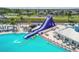 Aerial view of a resort-style water park with slides and a large pool at 9114 Forge Breeze Loop, Wesley Chapel, FL 33545