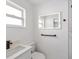 Clean bathroom featuring a white vanity and a large mirror at 10264 Oakhurst Rd, Largo, FL 33774