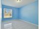 Simple bedroom with light blue walls and tiled floors at 10323 Del Mar Cir, Tampa, FL 33624