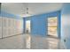 Spacious bedroom with light blue walls and tile floors at 10323 Del Mar Cir, Tampa, FL 33624