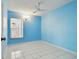 Bright bedroom with light blue walls, tiled floor, and double-door closet at 10323 Del Mar Cir, Tampa, FL 33624
