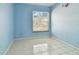 Small bedroom with light blue walls and tile floors at 10323 Del Mar Cir, Tampa, FL 33624