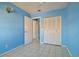 Light blue bedroom with tile floors and double door closet at 10323 Del Mar Cir, Tampa, FL 33624