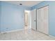 Simple bedroom with light blue walls, tiled floors, and access to a bathroom at 10323 Del Mar Cir, Tampa, FL 33624