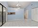 Dining room with tile floors, light blue walls, and a pass-through to kitchen at 10323 Del Mar Cir, Tampa, FL 33624