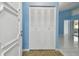 Entryway with tiled floor, blue walls, and a louvered closet at 10323 Del Mar Cir, Tampa, FL 33624