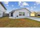 Brightly lit house with a side yard and attached garage at 10323 Del Mar Cir, Tampa, FL 33624