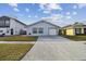 Newly remodeled home with a driveway and landscaped front yard at 10323 Del Mar Cir, Tampa, FL 33624